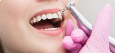 a dentist is doing dental hygiene in Leigh